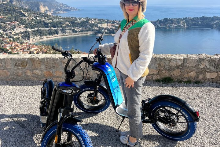 a person sitting on a motorcycle in front of a beach